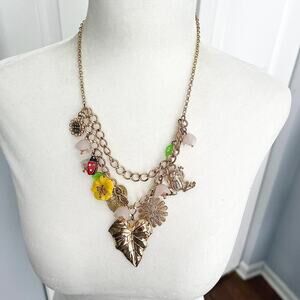 Gold tone double strand charm necklace ladybug frog leaf flower